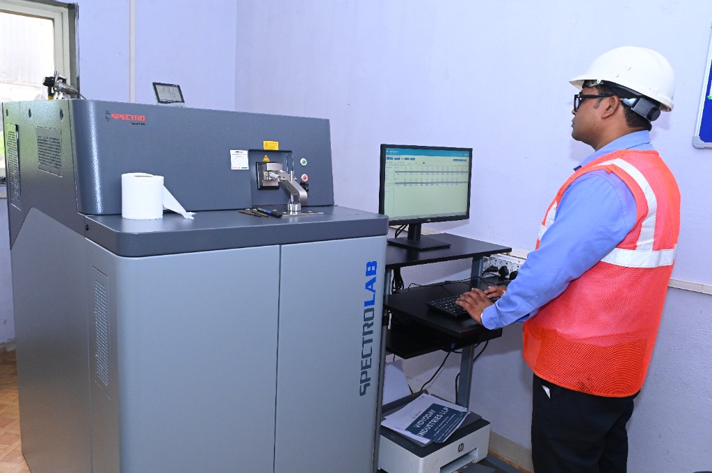 Technician operating Spectrolab optical emission spectrometer for alloy verification and compliance testing